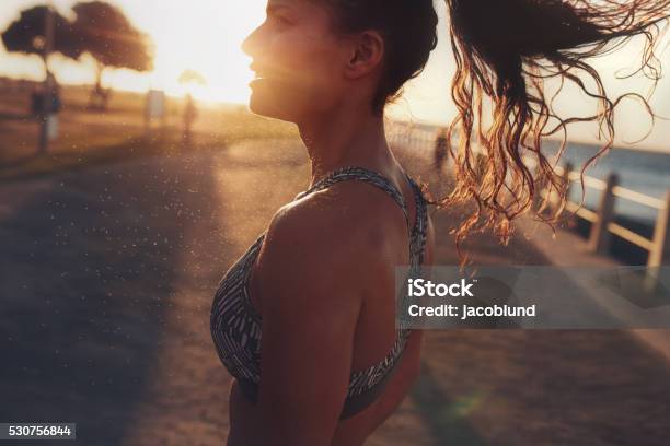 Fitness Woman Standing Outdoors During Evening Stock Photo - Download Image Now - Beach, Women, One Woman Only