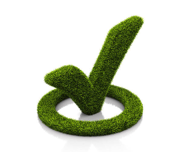 Green grassed check mark symbol in the circle on white stock photo