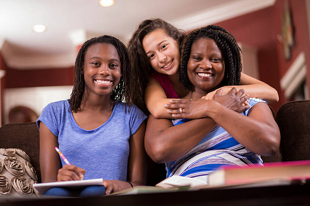 familia multiétnica. niñas adolescentes y mamá en su casa mirando, hablando. - high school student group of people smiling african ethnicity fotografías e imágenes de stock