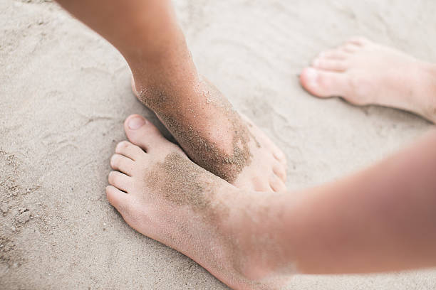 istock Kids' feet on a sand 530760021