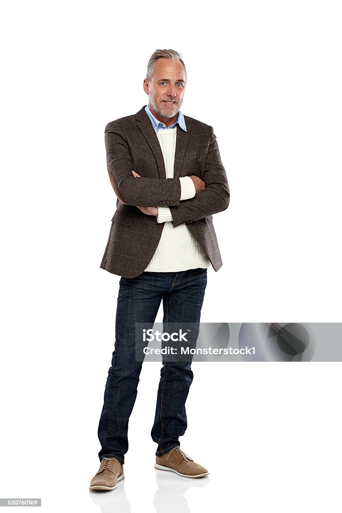 Handsome mature man standing confidently Studio shot of handsome mature man standing with his arms crossed on white background Men Stock Photo