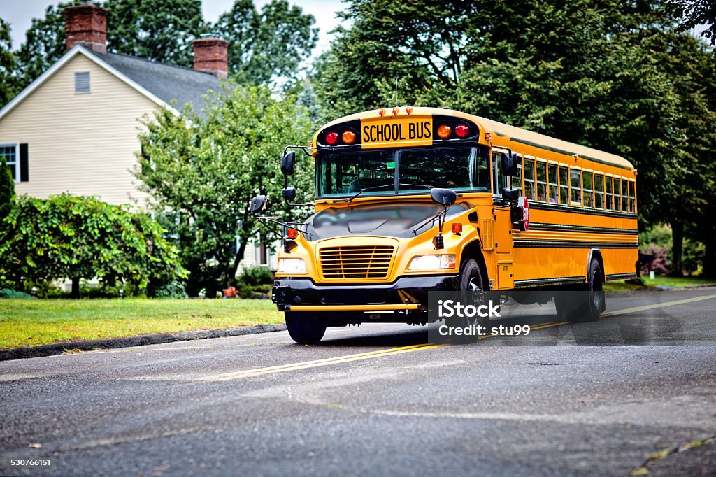 School bus Yellow school bus driving along street School Bus Stock Photo