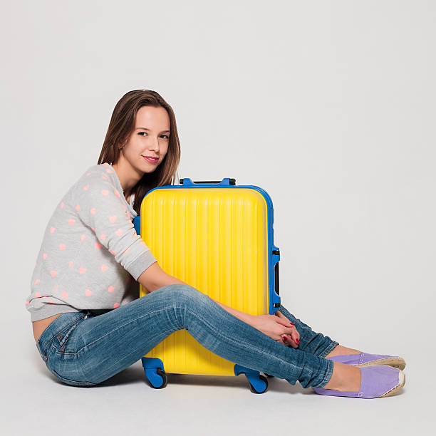 istock Girl with a yellow suitcase 530766243