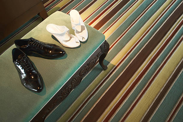 Groom and bride shoes in the hotel room. Wedding groom and bride shoes near canopy bed in beautiful and spacious luxury hotel room. Wedding preparation. oxford michigan photos stock pictures, royalty-free photos & images