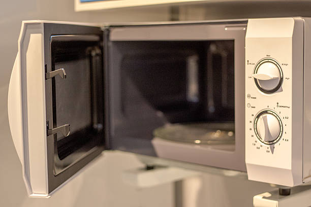 istock vacant microwave oven with door open 530766589