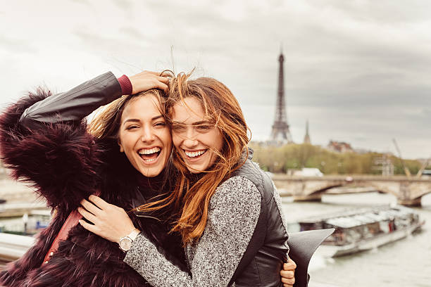 Happy girls in Paris against the Eiffel tower Happy girls on a vacation in Paris girl in paris stock pictures, royalty-free photos & images