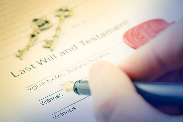 Man is preparing to sign a form Vintage / retro style : Man's right hand with fountain pen preparing to sign a form of last will and testament. A form is sealed with sealing wax and stamped / embossed with alphabet letter B. funeral planning stock pictures, royalty-free photos & images