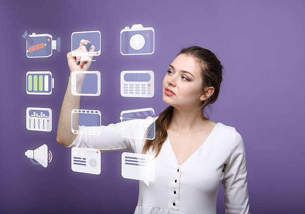 istock Woman pressing multimedia and entertainment icons on a virtual background 530768678