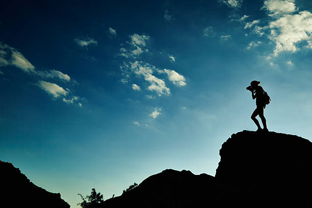 istock Woman silhouette at sunset in mountains 530770227