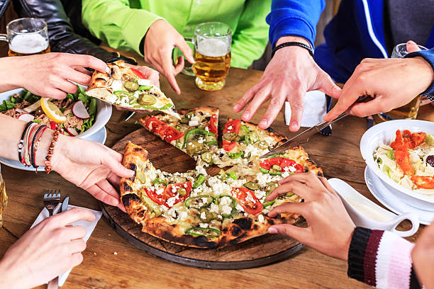 istock Friends taking pizza slices 530771340
