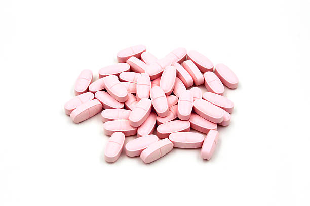 istock Pink pills on white background 530771693