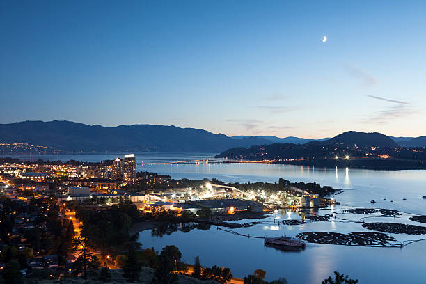 Kelowna at Night Okanagan Lake British Columbia Beautiful City of Kelowna in the evening. Image taken from Knox Mountian, from a tripod. Notice the heart shaped log bom. kelowna-autumn stock pictures, royalty-free photos & images