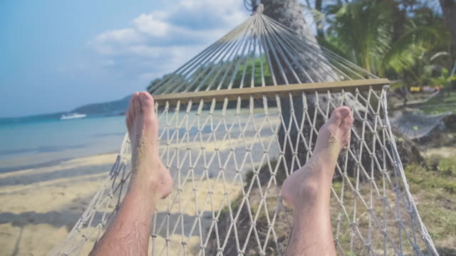 Feets in a hammock, Relaxing on the beach, ocean view