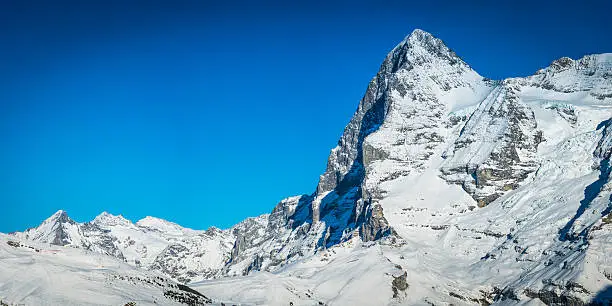 The iconic North Face of the Eiger (3970m) soaring above the ski resort of Kleine Scheidegg deep in the Bernese Alps of Switzerland. ProPhoto RGB profile for maximum color fidelity and gamut.