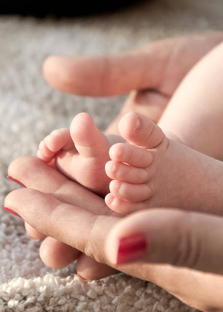 istock Foot of newborn 530782529