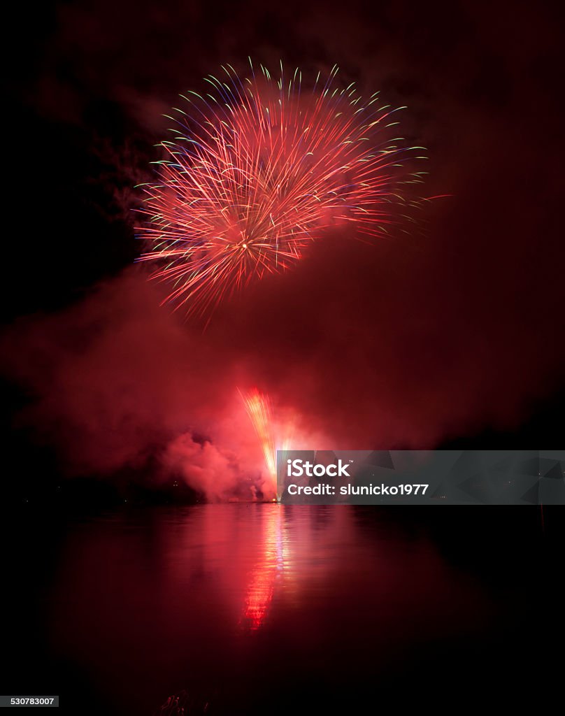 Colorful fireworks on black sky background with water reflections Abstract Stock Photo