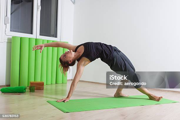 Stretching While Doing Yoga Stock Photo - Download Image Now - Active Lifestyle, Activity, Adult