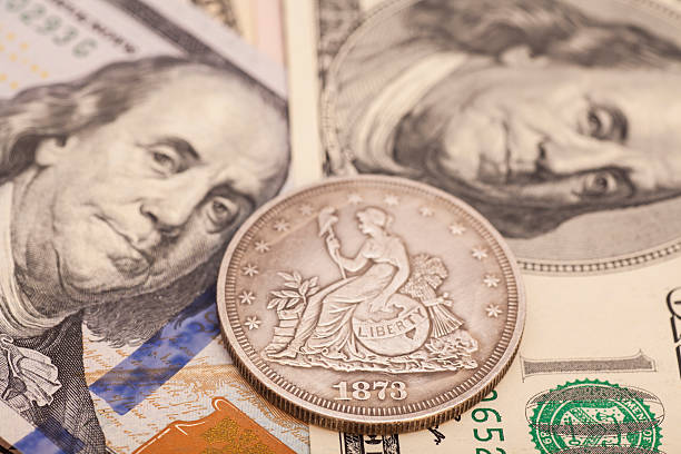 istock US dollar bills and coin 530783409
