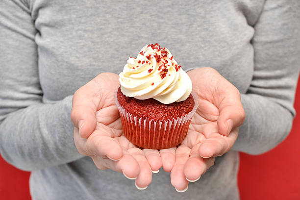 istock Woman with cupcake in hands 530783895