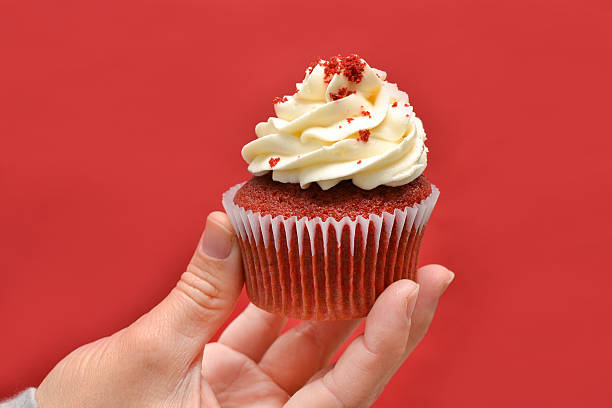 istock Woman with cupcake in hand 530783901