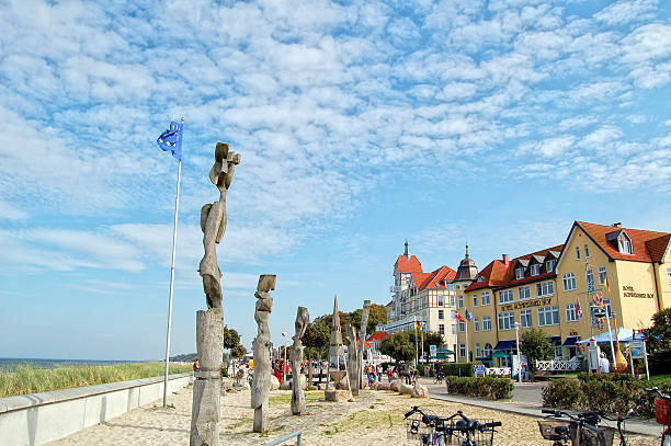 Kuehlungsborn, Germany - September 16, 2006: Cityscape of Kuehlungsborn (Mecklenburg-Vorpommern, Germany). People visiting the tourist city Kühlungsborn with its historical houses directly on the beach of baltic sea. Along the promenade are restaurants and outside bars.