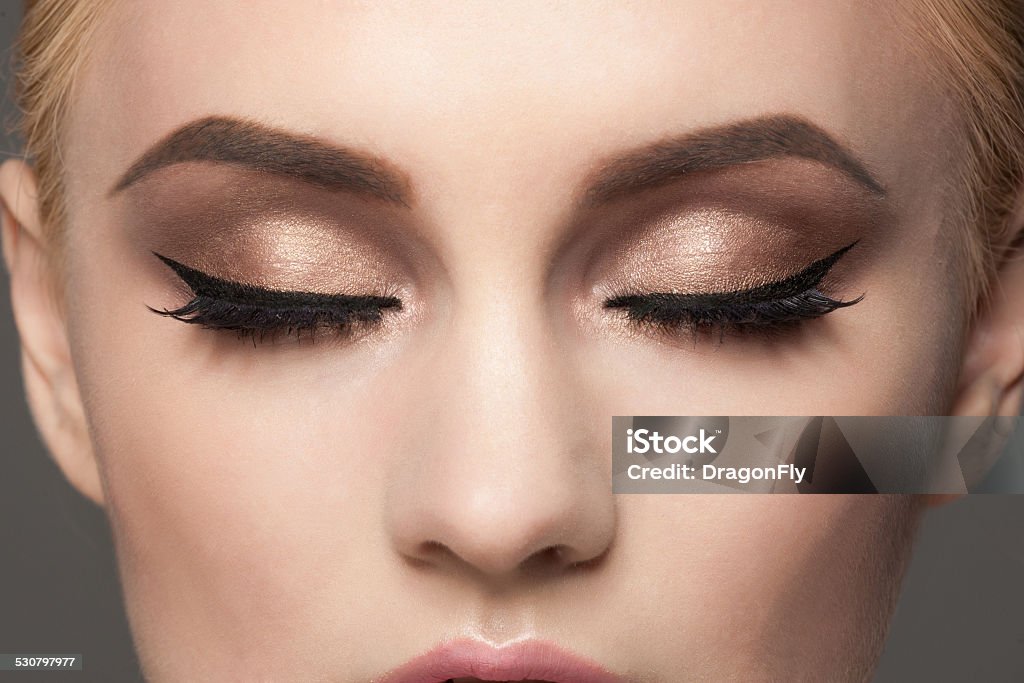 Closeup of eye makeup Closeup image of woman closed eyes with beautiful bright makeup. Makeup with eyeliner and falce eyelashes Eyeliner Stock Photo