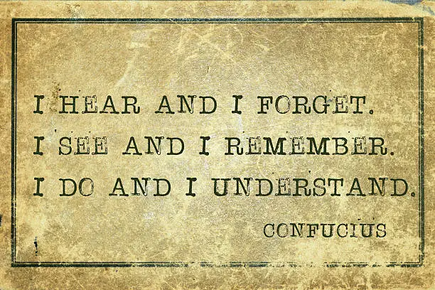 I hear and I forget - ancient Chinese philosopher Confucius quote printed on grunge vintage cardboard.
