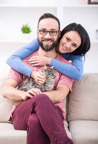 istock Beautiful young couple with their cat 530798881