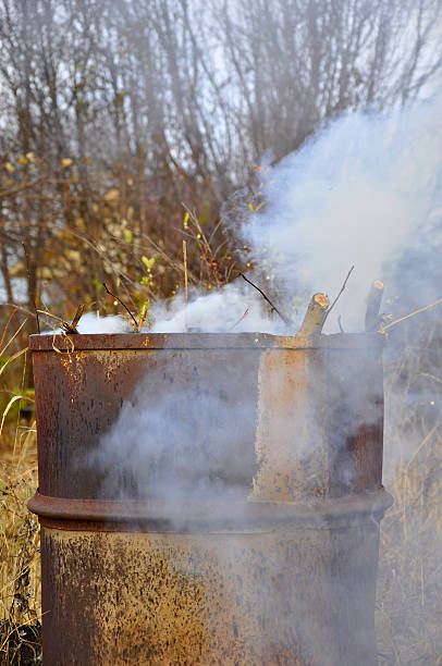 istock Smoke from a barrel with garbage on a country site 530800123