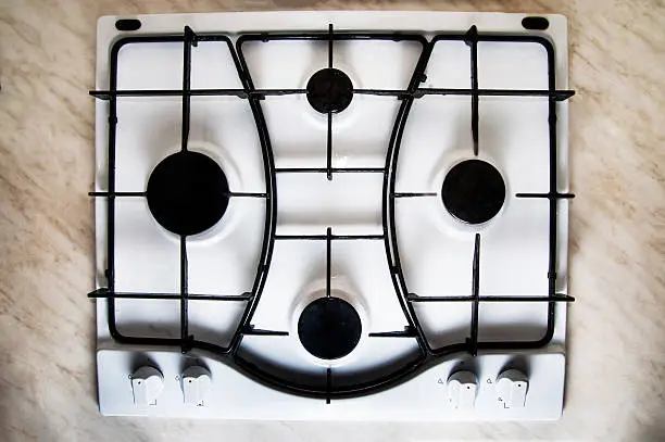 White gas stove, top view, four burners