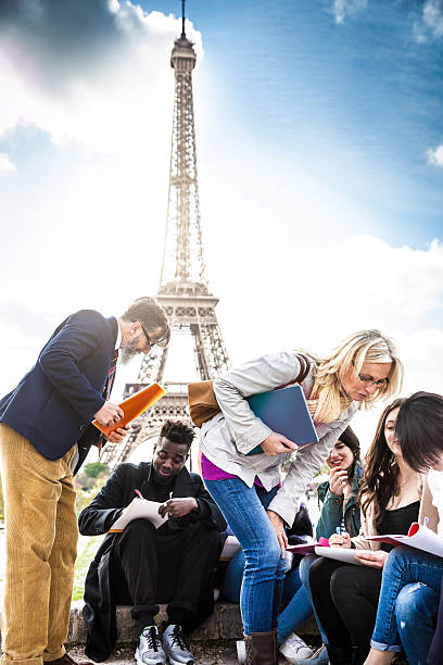 istock Students on travel in Paris - Tour Eiffel Outdoor lesson 530806078