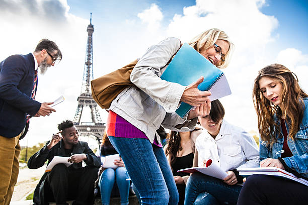 istock Students on travel in Paris - Tour Eiffel Outdoor lesson 530806384