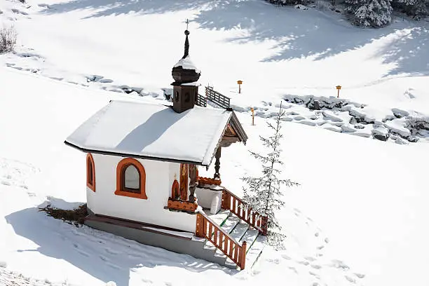 A small chapel in the snow in the Austrian Alps.