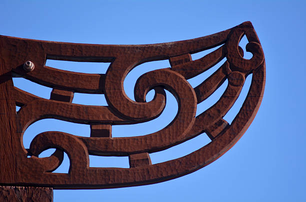 Maori culture - wood carving Auckland, New Zealand - June 01, 2014: Maori wood carving decoration. Maori are the indigenous people of New Zealand. Originally from Polynesia, Maori migrated to New Zealand over 1000 years ago. totem pole face stock pictures, royalty-free photos & images