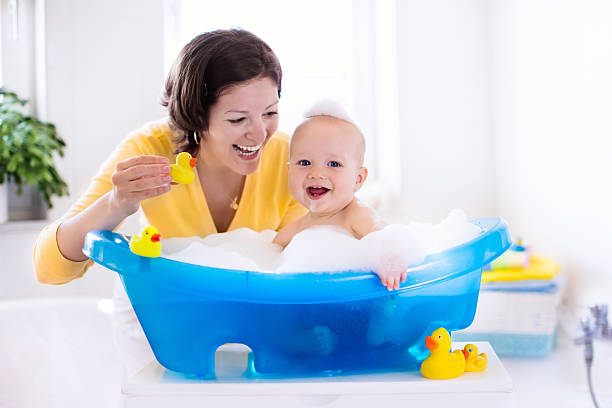 istock Young mother bathing baby boy 530809512
