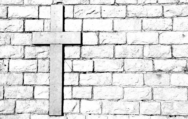 istock cross carved on marble attached to the stone wall 530809754