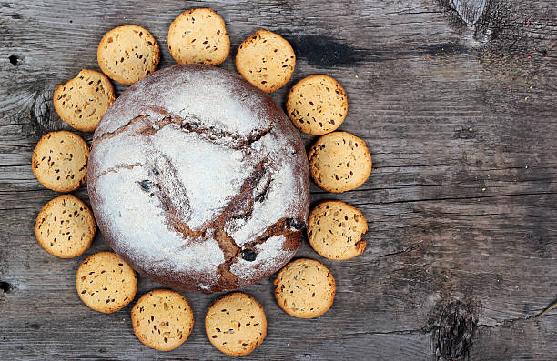 istock Loaf of bread and bisquits on old wooden table 530812306