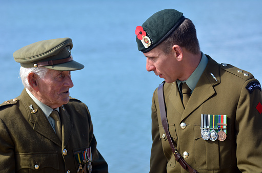 Mangonui, New Zealand - April 25, 2014: New Zealand Army veteran soldiers talks after the National War Memorial Anzac Day services in New Zealand.