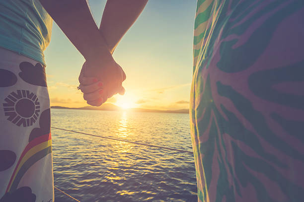 istock Couple of lovers holding hands at sunset 530812708