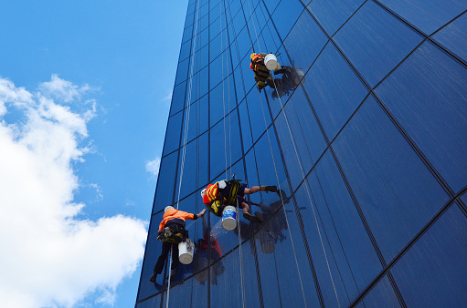 Melbourne, Australia - April 14, 2014: Window cleaners works on high rise building in Melbourne, Australia. Window cleaning is considered one of the most dangerous job in the world. Several window cleaners die each year and many are injured