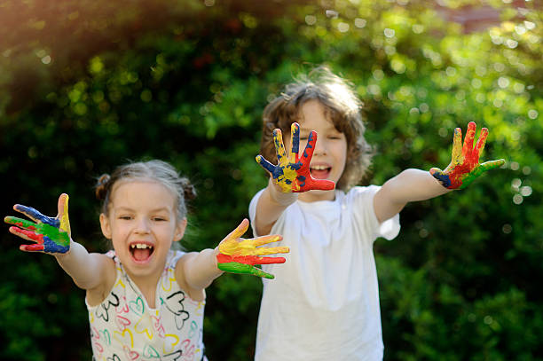 istock Children soiled with paint and show dirty hands 530813390