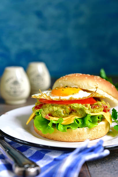 istock Vegetarian burger with guacamole and roasted egg. 530813398