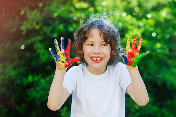 istock Young boy smile and show his colorful hands 530813466
