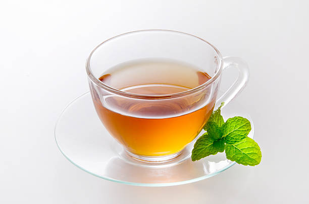 Tea of the herb made ​​with mint Tea that has entered into a glass of tea cup cordyline fruticosa stock pictures, royalty-free photos & images