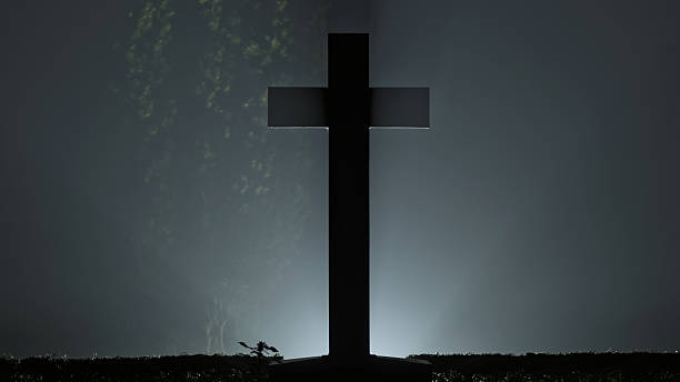 istock Christian cemetery Cross with back light in fog 530814618