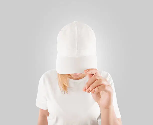 Blank white baseball cap mockup template, wear on women head, isolated, clipping path. Woman in clear hat and t shirt uniform mock up holding visor of caps. Cotton basebal cap design on delivery guy.