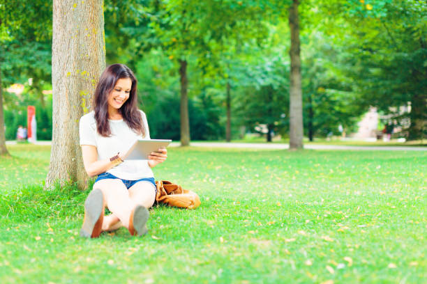 istock young people relaxing in the park 530816071