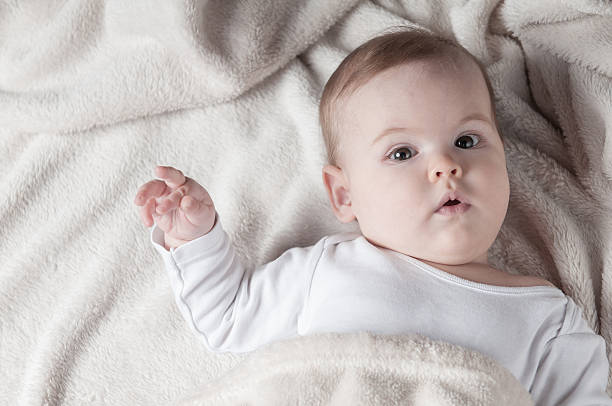 Beautiful little girl lying on her back and posing