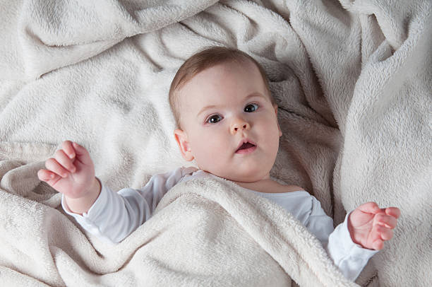 istock Beautiful little girl lying on her back and posing 530816442