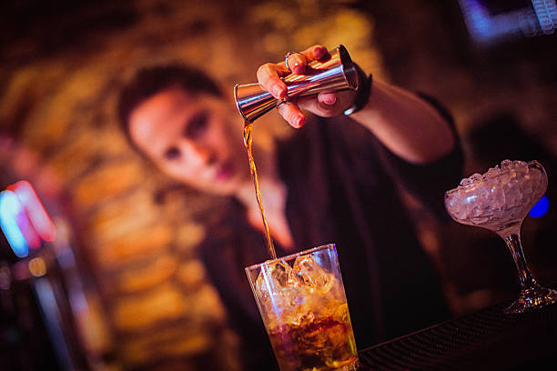 istock Midsection of young female bartender preparing cocktail in cocktail bar 530818416